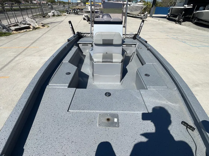 Slide: The Image of 2022 Xpress H20B Bay Boat with spacious deck and seating, parked outdoors. - 11