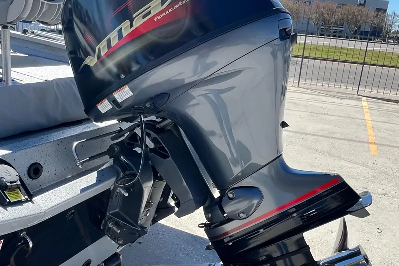 Slide: The Image of 2022 Xpress H20B Bay Boat with powerful outboard motor in a parking lot. - 14