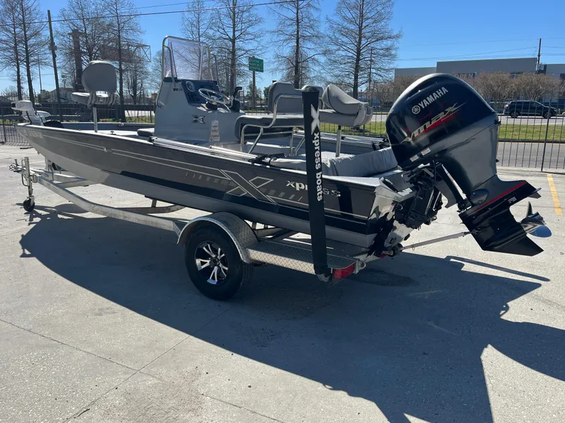 Slide: The Image of 2022 Xpress H20B Bay Boat with Yamaha outboard engine on trailer. - 4