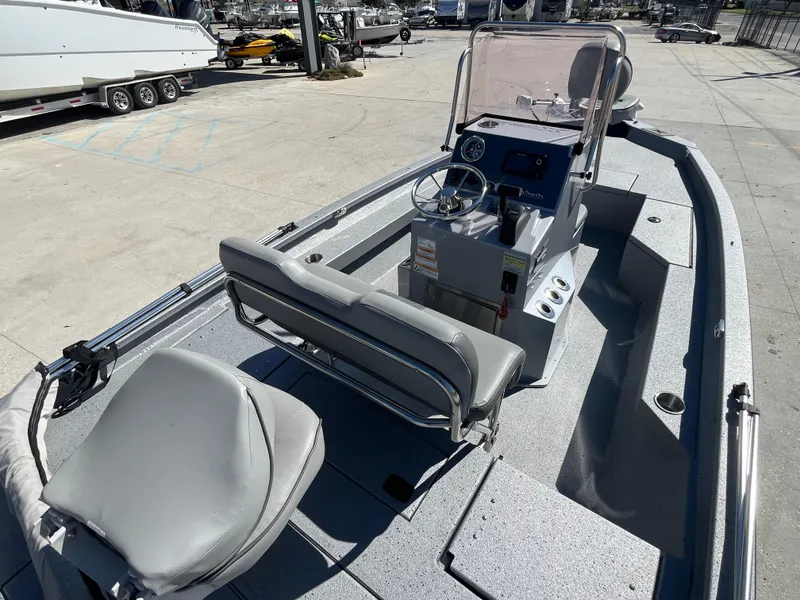 Slide: The Image of 2022 Xpress H20B Bay Boat with console and seating, docked in a marina. - 6