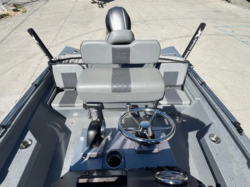 Slide: The Image of 2022 Xpress H20B Bay Boat interior with steering wheel and seating. - 8