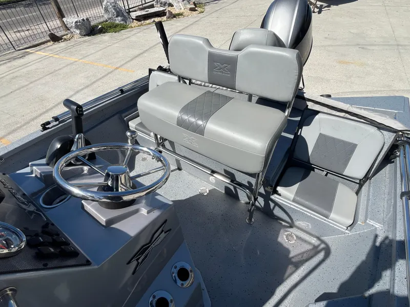 Slide: The Image of 2022 Xpress H20B Bay Boat interior with steering wheel and seating. - 9