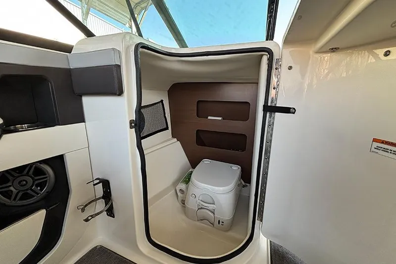 Slide: The Image of 2016 Sea Ray 220 Sundeck Outboard interior with compact marine toilet. - 11