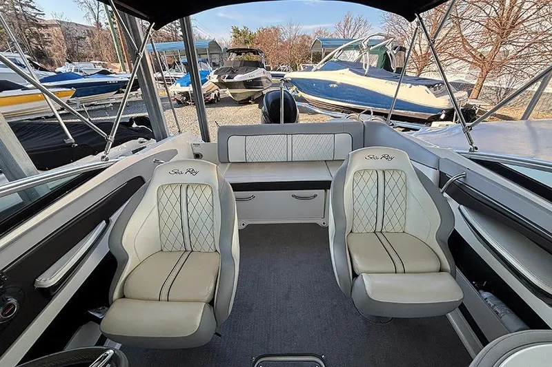 Slide: The Image of 2016 Sea Ray 220 Sundeck Outboard interior with plush seating and elegant design. - 13