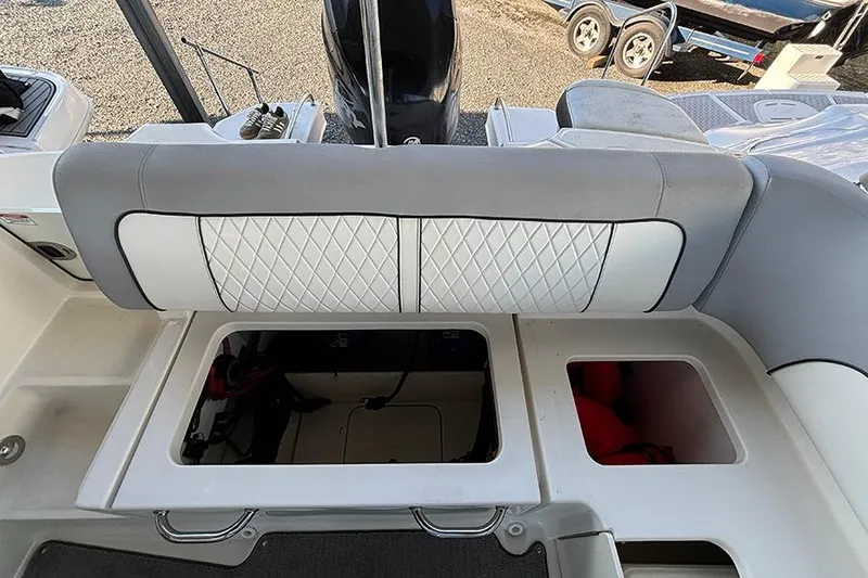 Slide: The Image of 2016 Sea Ray 220 Sundeck Outboard boat interior with storage compartments and seating. - 17