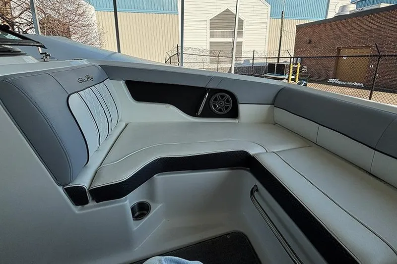 Slide: The Image of 2016 Sea Ray 220 Sundeck Outboard interior with comfortable seating and speaker. - 8