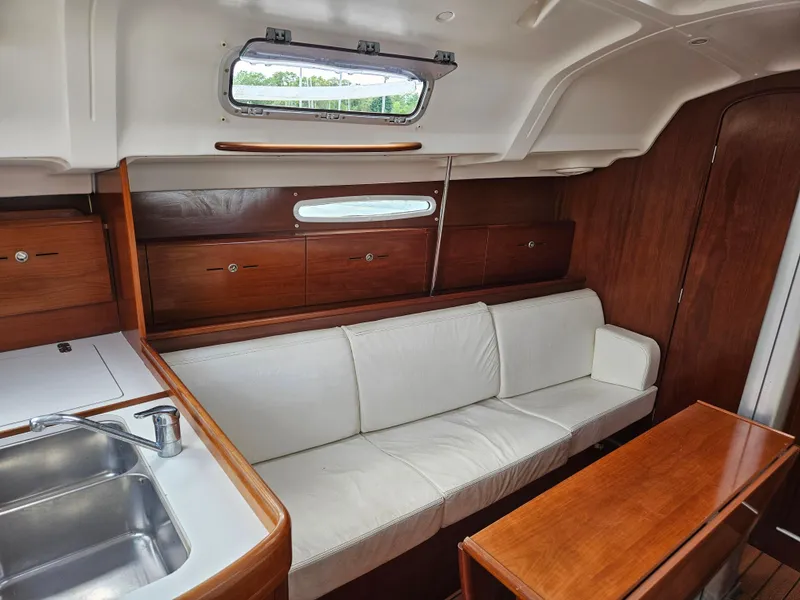 Slide: The Image of Interior of 2006 Beneteau First 36.7 yacht with white sofa and wooden cabinetry. - 10