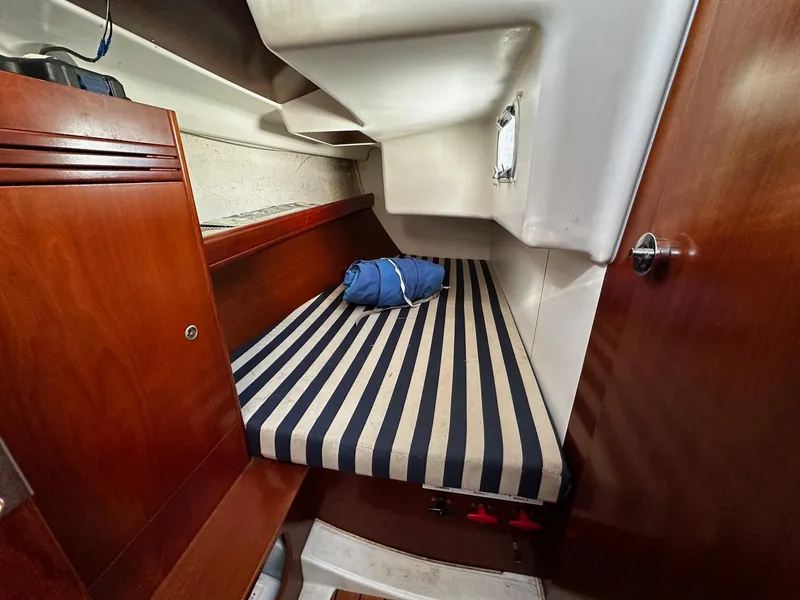 Slide: The Image of Cozy cabin interior of 2006 Beneteau First 36.7 sailboat with striped bedding. - 11