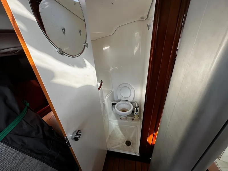 Slide: The Image of 2006 Beneteau First 36.7 yacht bathroom with toilet and mirror. - 14