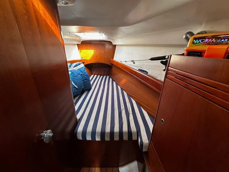 Slide: The Image of Cozy cabin interior of 2006 Beneteau First 36.7 sailboat with striped bedding. - 15