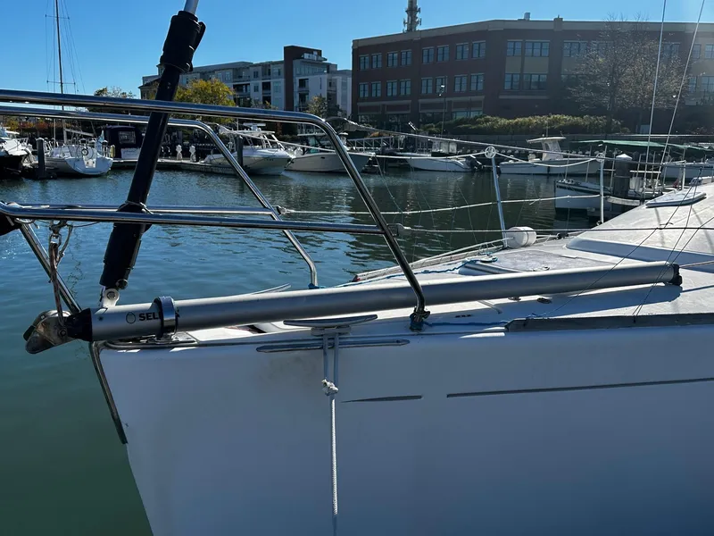 Slide: The Image of Sailboat Beneteau First 36.7, 2006 model, docked in a marina with buildings in the background. - 22