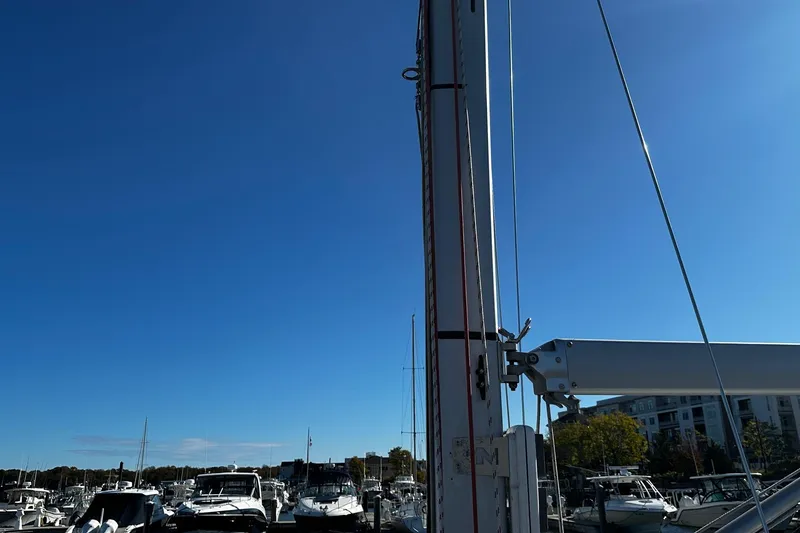 Slide: The Image of Sailboat mast of a 2006 Beneteau First 36.7 in a marina under clear blue sky. - 28