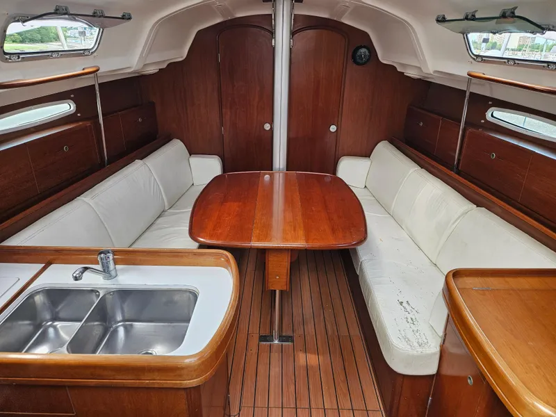 Slide: The Image of Interior of 2006 Beneteau First 36.7 sailboat with wood finish and white seating. - 6
