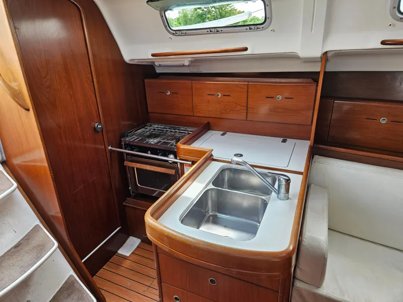 Slide: The Image of Interior of 2006 Beneteau First 36.7 yacht with wooden cabinetry and compact kitchen. - 7