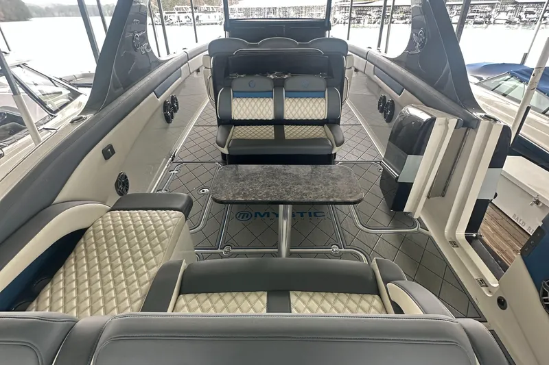 Slide: The Image of 2017 Mystic Powerboats M4200 interior with luxurious seating and table. - 10