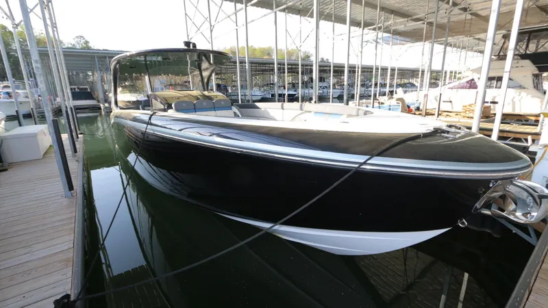 Slide: The Image of 2017 Mystic Powerboats M4200 docked in a marina, showcasing sleek black design. - 11
