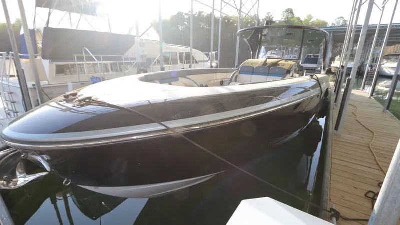 Slide: The Image of 2017 Mystic Powerboats M4200 docked, sleek black design, luxury motorboat. - 12