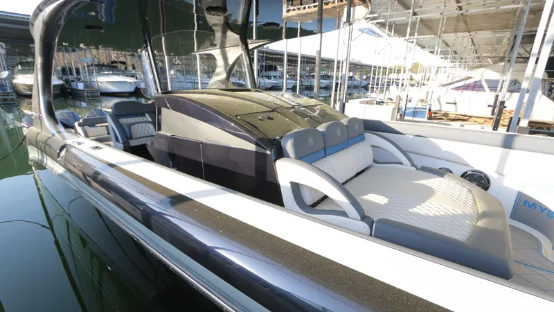 Slide: The Image of 2017 Mystic Powerboats M4200, sleek design, luxury seating, docked in marina. - 14