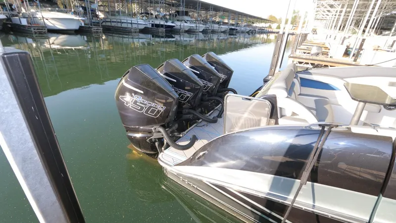 Slide: The Image of 2017 Mystic Powerboats M4200 with quad engines docked in a marina. - 16