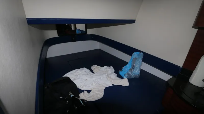 Slide: The Image of 2017 Mystic Powerboats M4200 cabin interior with bedding and personal items. - 22