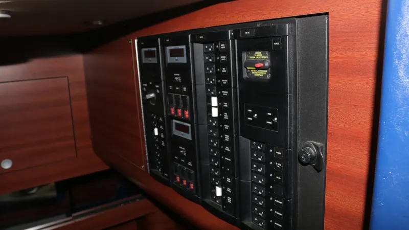 Slide: The Image of Electrical control panel on 2017 Mystic Powerboats M4200, featuring switches and circuit breakers. - 26