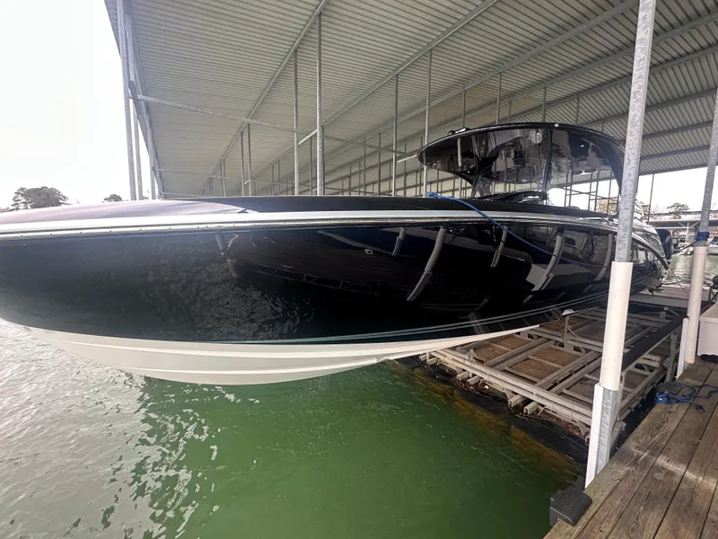 Slide: The Image of 2017 Mystic Powerboats M4200 docked under a covered marina. - 3