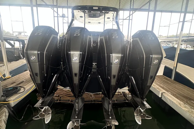 Slide: The Image of 2017 Mystic Powerboats M4200 with four powerful outboard engines docked in a marina. - 4