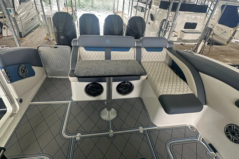 Slide: The Image of 2017 Mystic Powerboats M4200 interior with seating, table, and speakers. - 5