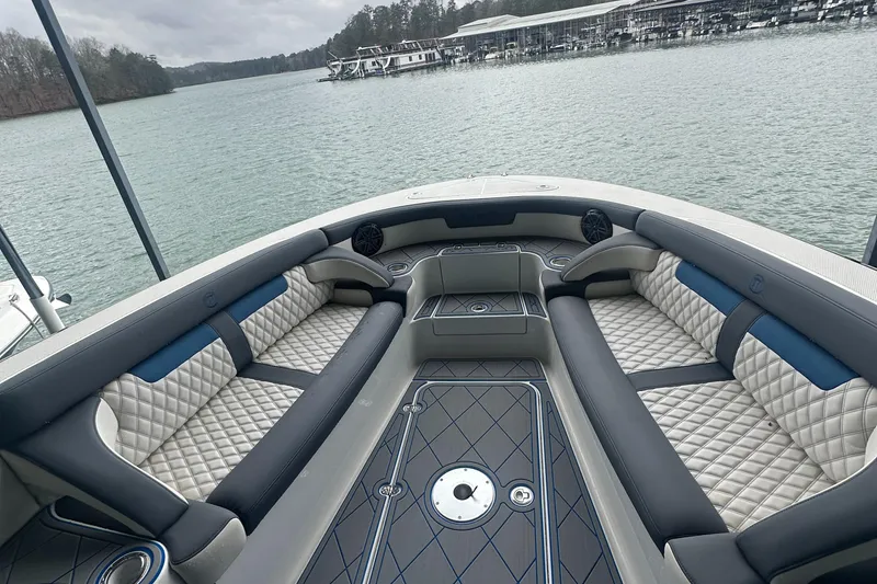 Slide: The Image of 2017 Mystic Powerboats M4200 interior with luxurious seating on a calm lake. - 7