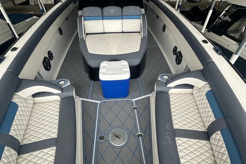 Slide: The Image of 2017 Mystic Powerboats M4200 interior with luxurious seating and cooler. - 8