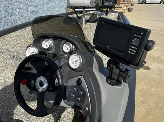 Slide: The Image of 2015 Tracker Pro Team 190 TX boat dashboard with steering wheel and electronic display. - 6