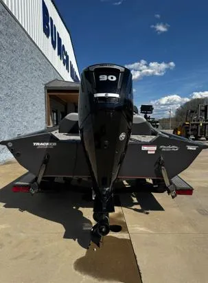 Slide: The Image of 2015 Tracker Pro Team 190 TX boat with 90 HP engine, parked outdoors. - 9