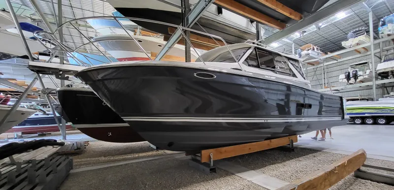 Slide: The Image of 2023 Cutwater C-288 boat in indoor storage, showcasing sleek design and modern features. - 0