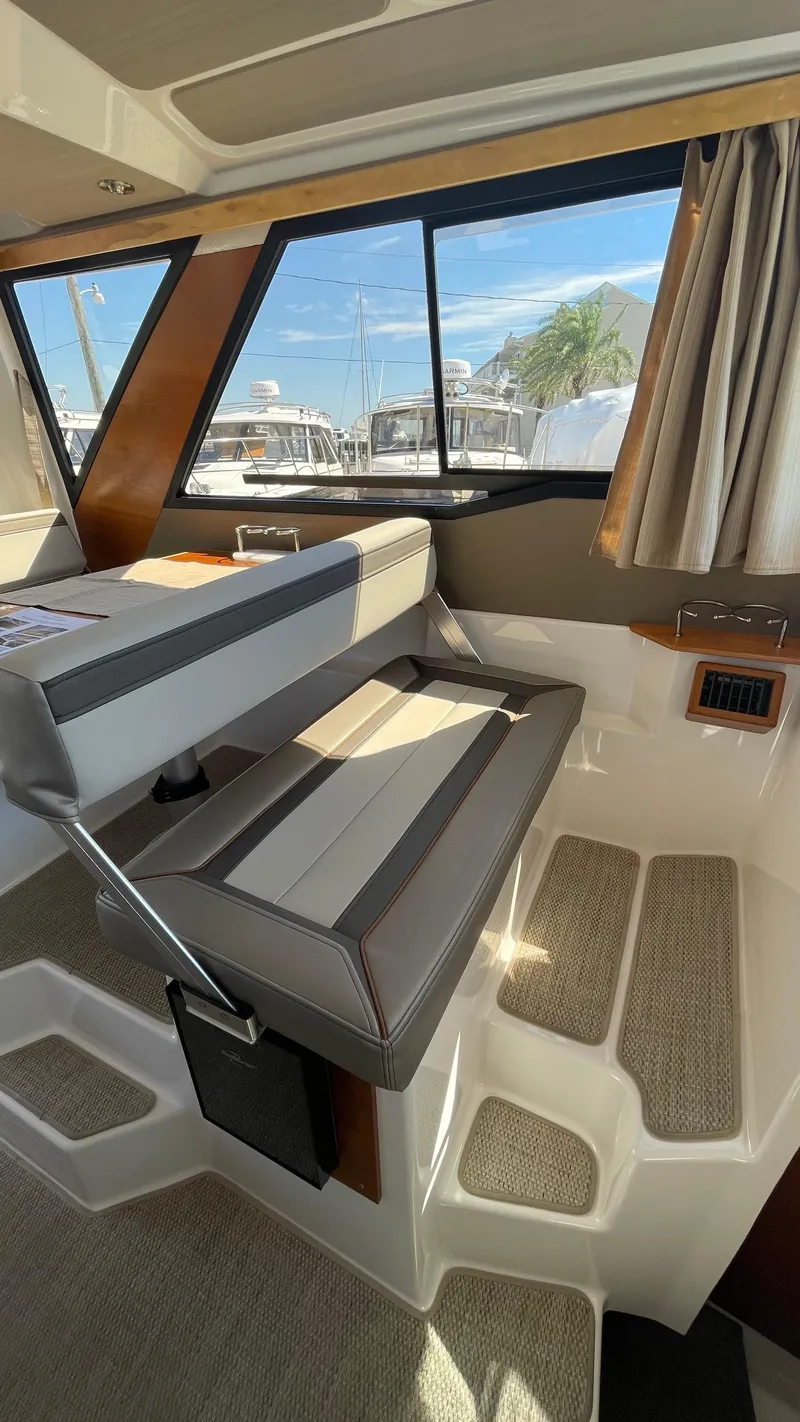 Slide: The Image of Interior of 2023 Cutwater C-288 boat with cushioned seating and large windows. - 22