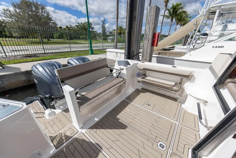 Slide: The Image of 2023 Cutwater C-288 boat deck with seating, dual engines, and modern design. - 25