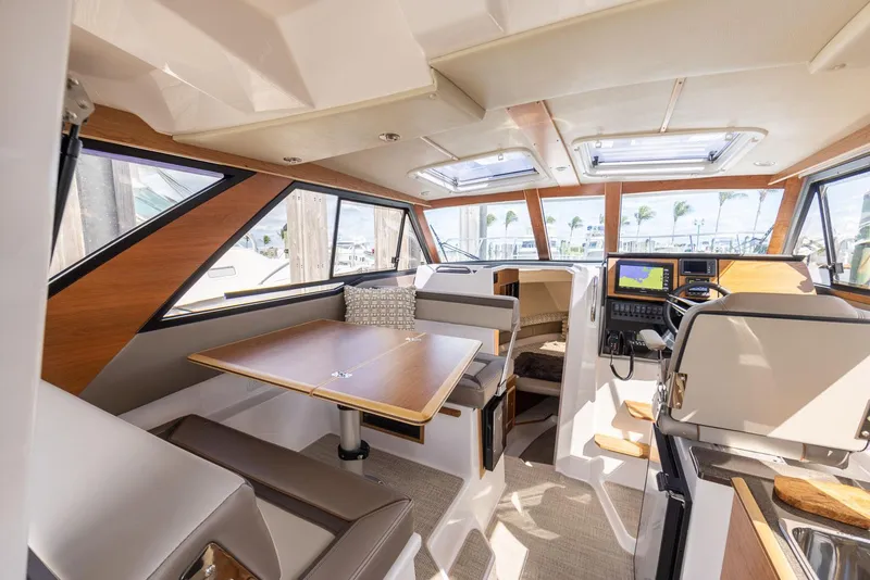 Slide: The Image of Interior of 2023 Cutwater C-288 boat, featuring modern seating and navigation area. - 27