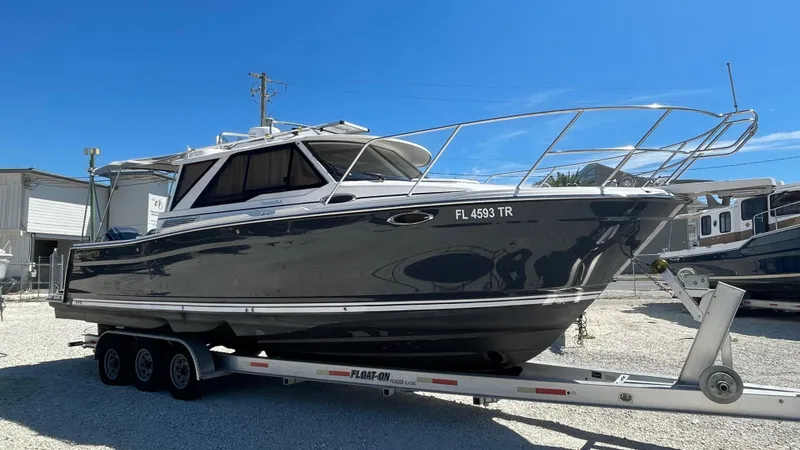 Slide: The Image of 2023 Cutwater C-288 boat on trailer under clear blue sky. - 3