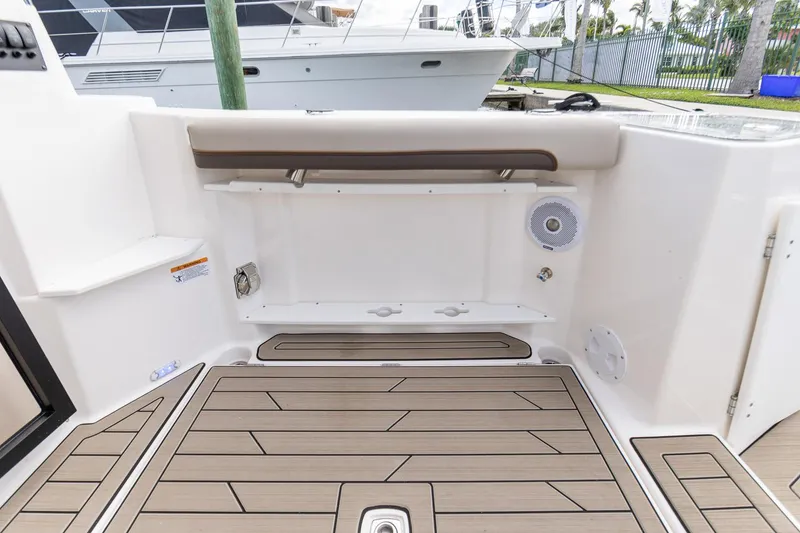 Slide: The Image of 2023 Cutwater C-288 boat deck with wood finish and storage compartments. - 6