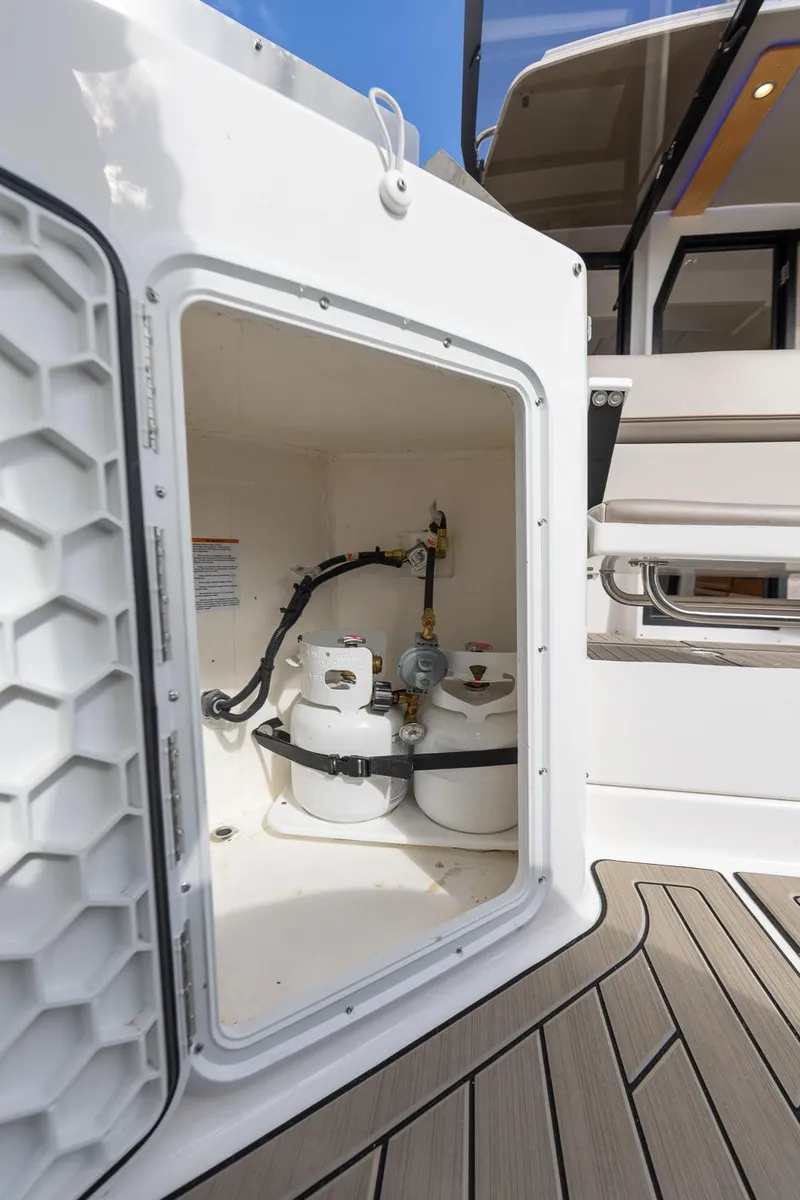 Slide: The Image of 2023 Cutwater C-288 boat storage compartment with propane tanks. - 7