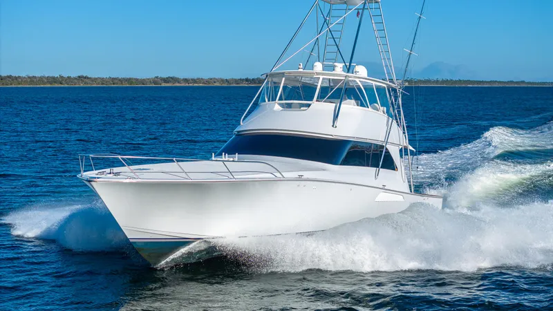 Slide: The Image of A 2004 Viking 2005 yacht cruising swiftly on open water under a clear blue sky. - 10