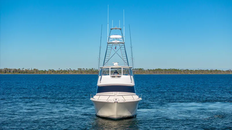Slide: The Image of Front view of a 2004 Viking 2005 boat on a calm blue lake. - 11