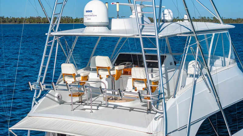 Slide: The Image of Luxury Viking 2005 yacht on blue water, featuring a spacious deck and seating area. - 13