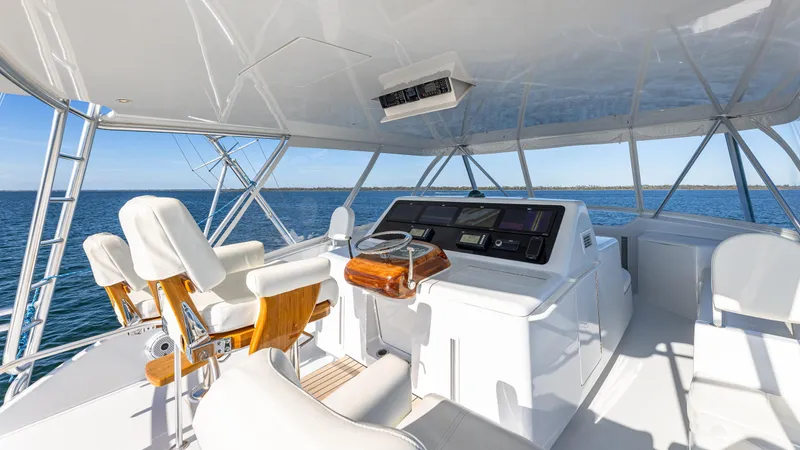 Slide: The Image of Luxury yacht helm with white seating, wooden accents, and ocean view; Viking 2005 model, 2004. - 14