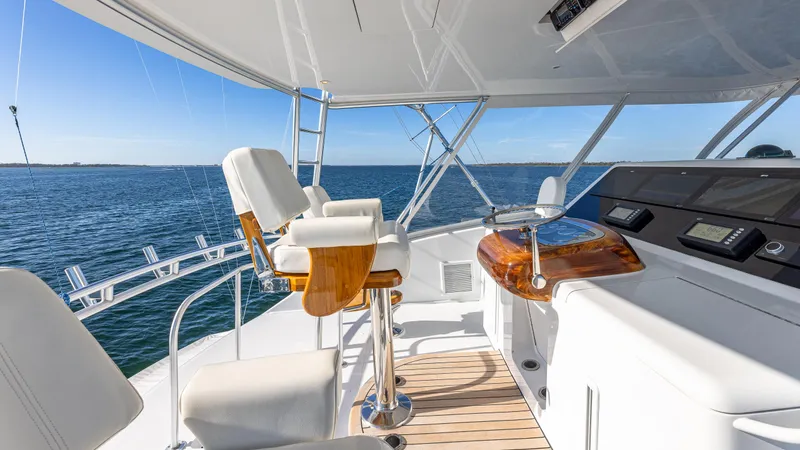 Slide: The Image of Luxury Viking 2005 yacht helm with ocean view, featuring sleek design and modern controls. - 16
