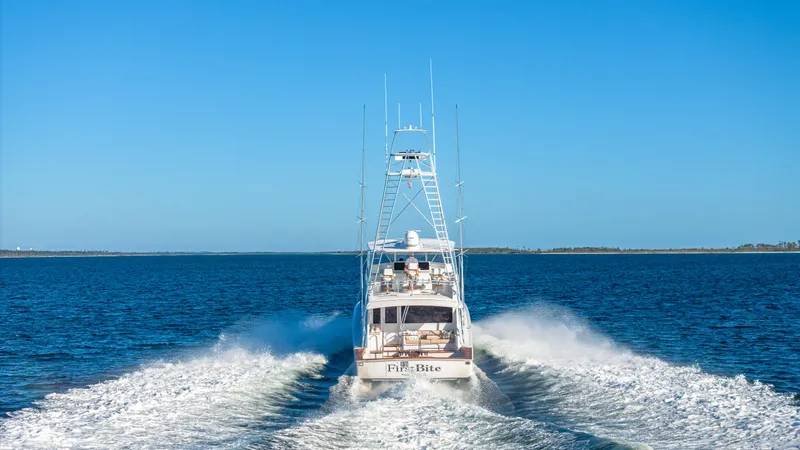 Slide: The Image of A 2004 Viking 2005 yacht cruising on open water under a clear blue sky. - 3