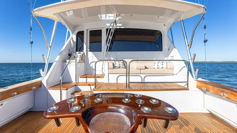 Slide: The Image of Luxury Viking 2005 yacht deck with seating, ocean view, and fishing rod holders. - 31