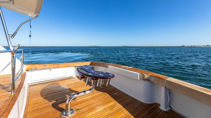Slide: The Image of Luxury Viking 2005 yacht deck with ocean view, featuring polished wood flooring. - 33