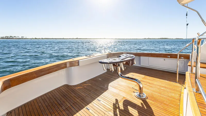 Slide: The Image of Luxury Viking 2005 yacht deck with ocean view, 2004 model, featuring wooden flooring and fishing station. - 35