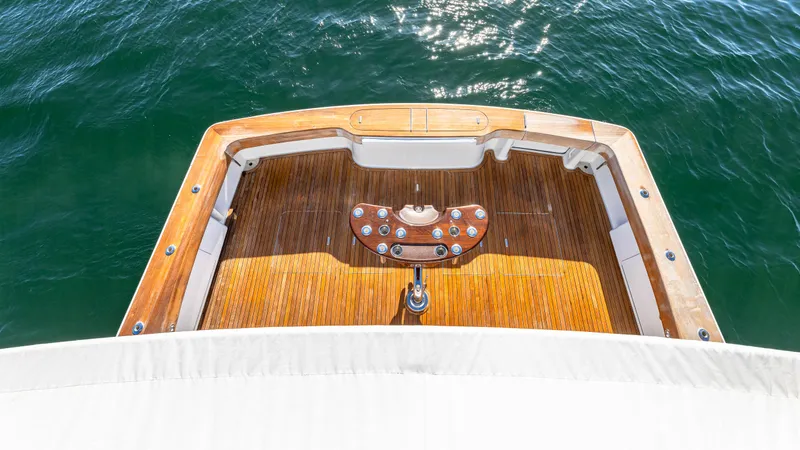 Slide: The Image of Sleek Viking 2005 yacht deck, 2004 model, with polished wood finish on open water. - 36