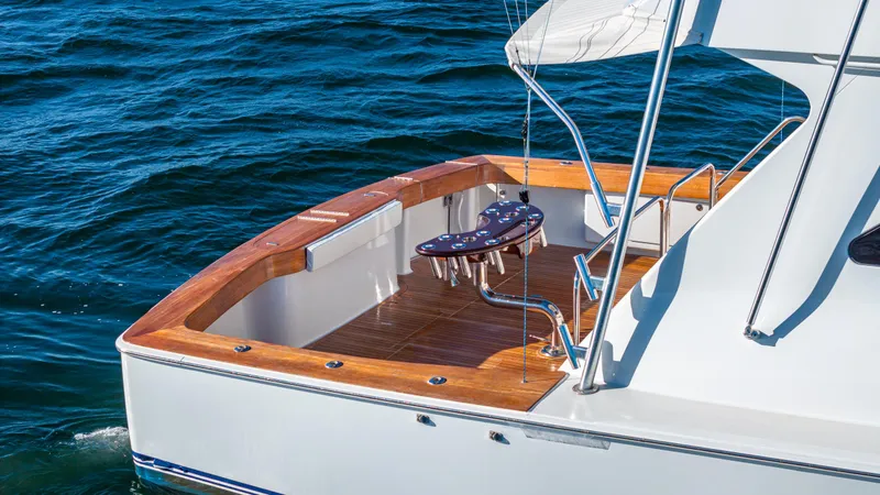 Slide: The Image of Luxury Viking 2005 yacht deck with wooden finish, 2004 model, on calm blue water. - 38